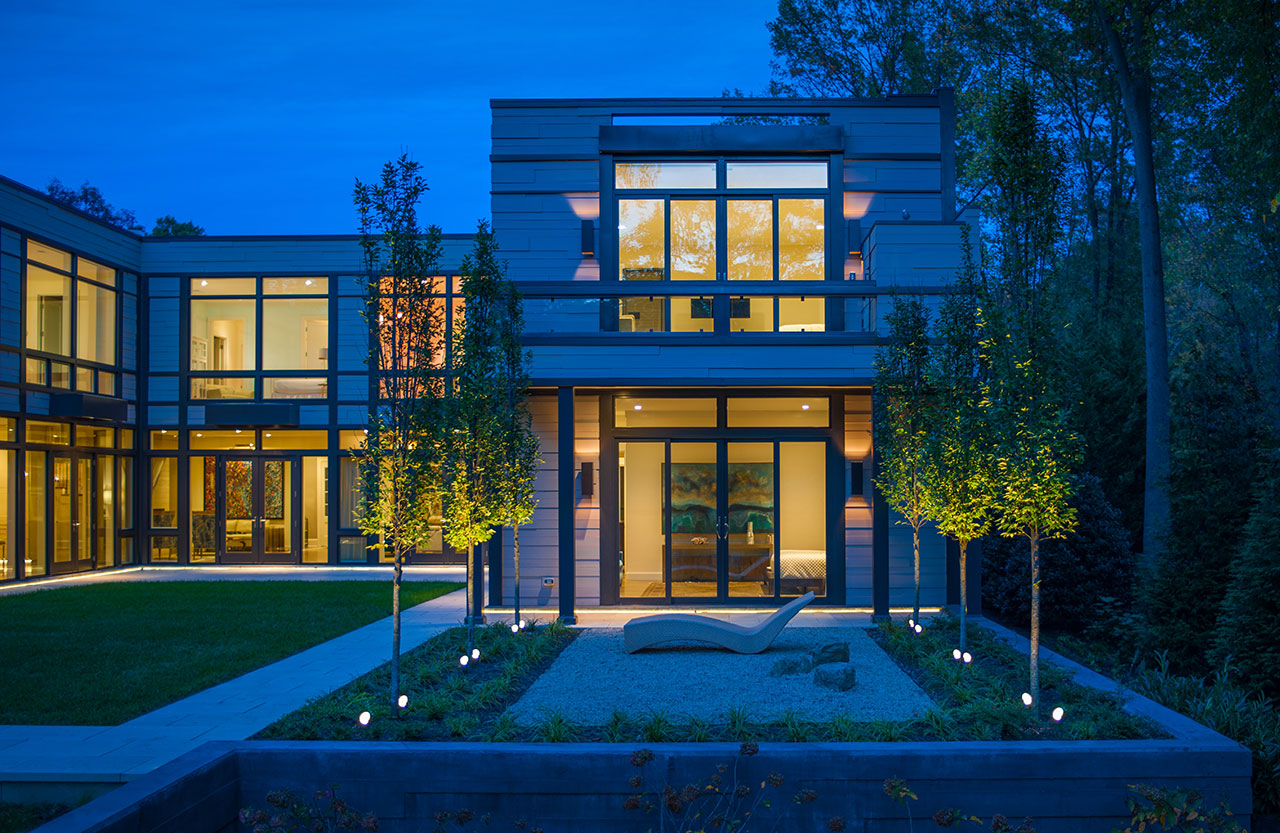 black-frame-swinging-patio-doors-modern-home-dusk